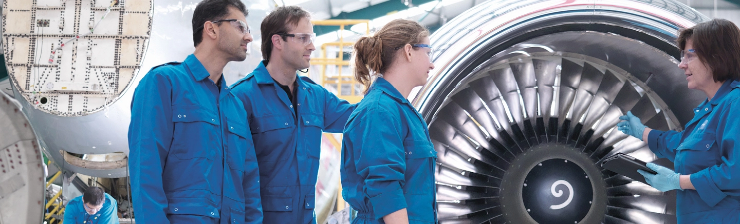 Engineers standing near airplane engine